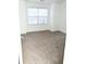 Spacious carpeted bedroom with large window at 2374 Suwanee Pointe Dr, Lawrenceville, GA 30043