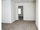 Bright bedroom with carpeted floor and access to another room at 2374 Suwanee Pointe Dr, Lawrenceville, GA 30043