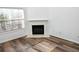 Cozy corner fireplace with a marble hearth and wood-look flooring at 2374 Suwanee Pointe Dr, Lawrenceville, GA 30043