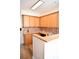 L-shaped kitchen with wood cabinets and granite countertops at 2374 Suwanee Pointe Dr, Lawrenceville, GA 30043