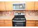 Kitchen features a cooktop and microwave at 2374 Suwanee Pointe Dr, Lawrenceville, GA 30043