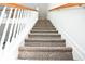 Carpeted staircase with wood railings leading to the upper level at 2374 Suwanee Pointe Dr, Lawrenceville, GA 30043