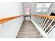 Staircase leading to the upper level with wooden railing and carpet at 2374 Suwanee Pointe Dr, Lawrenceville, GA 30043