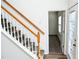 Staircase with wooden railing and neutral wall colors at 2374 Suwanee Pointe Dr, Lawrenceville, GA 30043