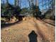 Large backyard with mature trees and a wooden fence at 3428 Vandiver Dr, Marietta, GA 30066