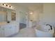 Elegant bathroom with soaking tub, walk-in shower, and double vanity at 443 Lothbury Ave, Locust Grove, GA 30248