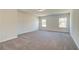 Spacious bedroom with carpet and neutral walls at 443 Lothbury Ave, Locust Grove, GA 30248