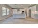 Modern kitchen with white cabinets and large island at 443 Lothbury Ave, Locust Grove, GA 30248