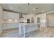 Modern kitchen with white cabinets and large island at 443 Lothbury Ave, Locust Grove, GA 30248