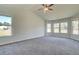 Spacious main bedroom with tray ceiling, carpet, and large windows at 443 Lothbury Ave, Locust Grove, GA 30248