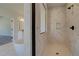 Spacious walk-in shower with marble tile and built-in shelving at 443 Lothbury Ave, Locust Grove, GA 30248