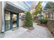 Exterior view of the community room entrance with walkway, garden, and seating area at 821 Ralph Mcgill Ne Blvd # 3216, Atlanta, GA 30306