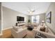 Bright living room with plush seating and a large-screen TV for comfortable and stylish living at 821 Ralph Mcgill Ne Blvd # 3216, Atlanta, GA 30306