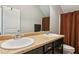 Bathroom with double sinks, granite countertop, and brown curtain at 100 Orchard Ln, Covington, GA 30014