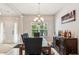Elegant dining room with a granite table, chandelier, and a wine bar at 100 Orchard Ln, Covington, GA 30014