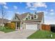 Green-sided house with brick accents, a two-car garage, and a well-manicured lawn at 100 Orchard Ln, Covington, GA 30014