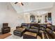 Open concept living room with a large sectional sofa and kitchen view at 100 Orchard Ln, Covington, GA 30014