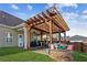 Wooden pergola with firepit and patio furniture at 100 Orchard Ln, Covington, GA 30014