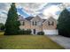 Brick house with 2-car garage, landscaping, and a spacious lawn at 286 Heathridge Se Ln, Mableton, GA 30126