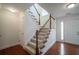 Elegant staircase with wood railings and carpeted steps at 286 Heathridge Se Ln, Mableton, GA 30126