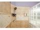 Shower with glass block wall and tile surround at 3955 Three Chimneys Ln, Cumming, GA 30041