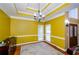 Formal dining room with hardwood floors and yellow walls at 3955 Three Chimneys Ln, Cumming, GA 30041
