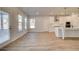 Open concept kitchen with white cabinets, island, and access to backyard at 604 Amabile Rd, Locust Grove, GA 30248