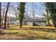 Private backyard with mature trees and view of home exterior at 1534 Alma Sw St, Atlanta, GA 30311