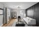 Modern living room with a white couch and dark accent wall at 1534 Alma Sw St, Atlanta, GA 30311