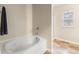 Relaxing bathroom with a garden tub and tile flooring at 3720 Liverpool Way, Atlanta, GA 30331