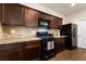 Modern kitchen featuring dark wood cabinets and granite countertops at 3720 Liverpool Way, Atlanta, GA 30331