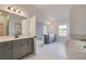 Bright bathroom with dual vanities, a freestanding tub, and a glass shower at 501 Dolce Rd, Locust Grove, GA 30248