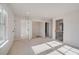 Spacious bedroom with neutral carpet, an open closet, and access to the staircase at 501 Dolce Rd, Locust Grove, GA 30248