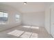 Bright bedroom with neutral carpet and two windows at 501 Dolce Rd, Locust Grove, GA 30248