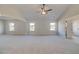 Large bedroom with neutral carpet, ceiling fan, and ample natural light at 501 Dolce Rd, Locust Grove, GA 30248