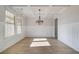 Formal dining room with a coffered ceiling, wainscoting, wood-look floors, and large windows at 501 Dolce Rd, Locust Grove, GA 30248