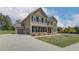 Two-story house with neutral siding, black shutters, and a brick facade at 501 Dolce Rd, Locust Grove, GA 30248