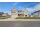 Charming two-story home featuring a brick and siding facade, and a spacious two-car garage at 501 Dolce Rd, Locust Grove, GA 30248