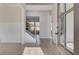 Inviting foyer with wood-look floors, a staircase, and a view into the adjacent living spaces at 501 Dolce Rd, Locust Grove, GA 30248