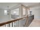 Second floor hallway with decorative iron railing and modern light fixtures at 501 Dolce Rd, Locust Grove, GA 30248