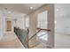 Upstairs hallway with decorative wrought iron railing and carpeted floors at 501 Dolce Rd, Locust Grove, GA 30248