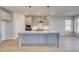Modern kitchen with a large center island, pendant lighting, and stainless steel appliances at 501 Dolce Rd, Locust Grove, GA 30248