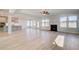 Open-concept living area with wood-look floors, fireplace, and windows allowing for natural light at 501 Dolce Rd, Locust Grove, GA 30248
