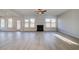 Bright living room featuring a fireplace, hardwood floors, recessed lights, and several windows at 501 Dolce Rd, Locust Grove, GA 30248