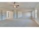 Main bedroom with neutral carpet, a ceiling fan, and access to the bathroom at 501 Dolce Rd, Locust Grove, GA 30248