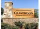 Stone and brick sign for the Crestwood Community with a natural wooden sign and manicured landscaping at 1070 Crest Mill Dr, Marietta, GA 30008