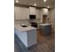 Modern kitchen with stainless steel appliances, white cabinets, gray island, and stone countertops at 1070 Crest Mill Dr, Marietta, GA 30008