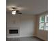Bright living room featuring a fireplace with gray floors and large windows with tree views at 1070 Crest Mill Dr, Marietta, GA 30008