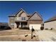 Two-story house with stone accents and a three-car garage at 1122 Cotton Oak Dr, Lawrenceville, GA 30045