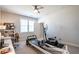 Bright bedroom repurposed into a home gym and office with neutral walls, ceiling fan, and natural light at 2760 Rustic Lake Ter, Cumming, GA 30041